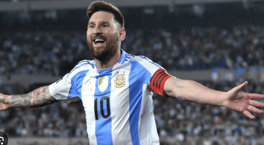 Lionel Messi raises his arms while running the field in a recent match for Argentina in file photo.