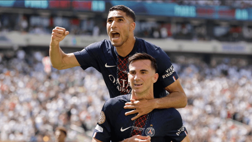 Fabian Ruiz (left) pumps his fist as he lands on the back of teammate Achraf Hakimi (right) in PSG's match against Real Madrid in a FIFAClub World Cup 2026 quarterfinals match on Wednesday. PSG vs Real Madrid sees Parisians reach CWC final vs Chelsea