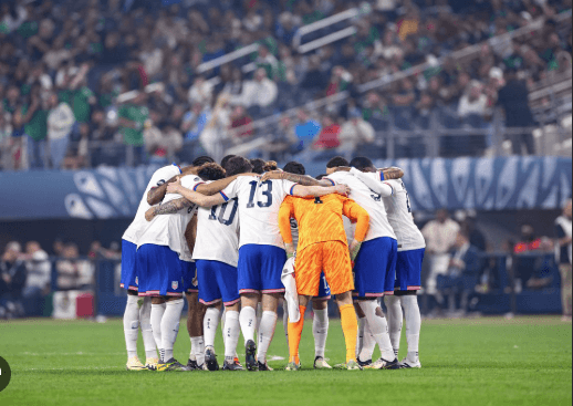 Players from the US Men's National Team (USMNT ), in white, gather at center field for a huddle during a match in file photo. USMNT's World Cup 2026 buildup resumes vs Ecuador, Australia