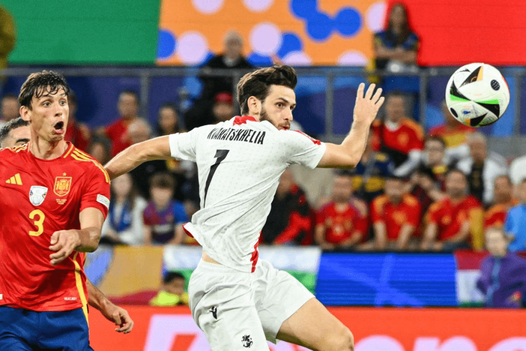 Khvicha Kvaratskhelia (7, right) chases the ball against Spain's Robin Le Normand (3, left) in file photo.