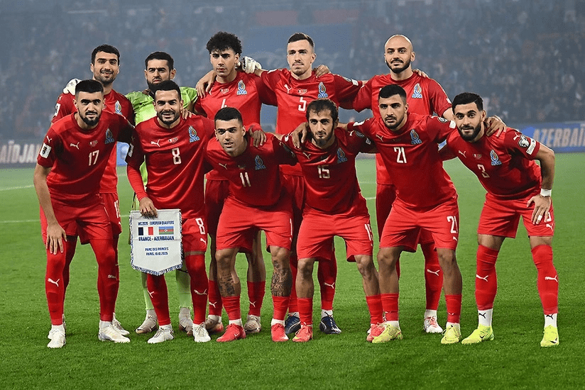{layers of Azerbaijan's men's football team gather in a huddle to pose for a picture in file photo.