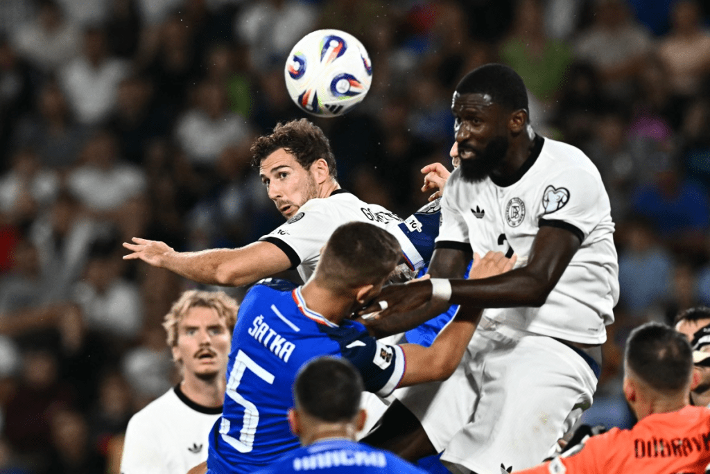 Two Germany players (in white shirts) swarm on Slovakia center-back Lubomir Satka (5, midd;e) in their September 5, 2025 UEFA World Cup Qualifying match.