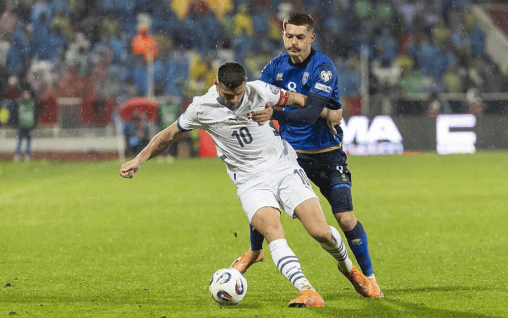 Switzerland's Granit Xhaka (10) battles fior ball possession against Kosovo's Florent Muslija in their teams' UEFA World Cup Qualifiers match on November 19, 2025.